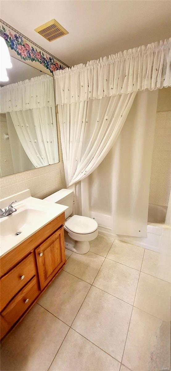 bathroom featuring tile patterned flooring, vanity, and toilet