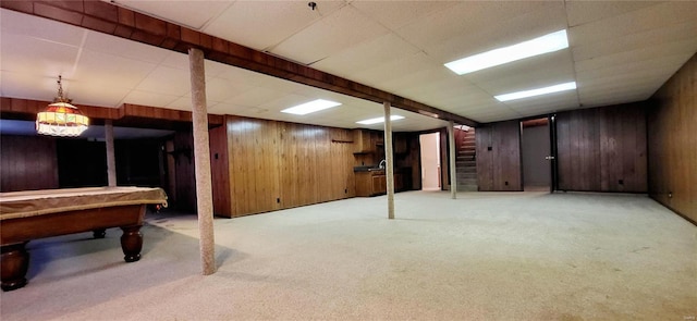 basement featuring wood walls, light colored carpet, and billiards