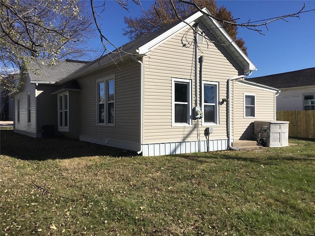 view of side of home featuring a yard