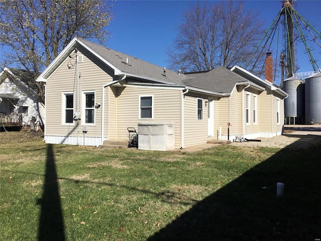 rear view of house with a yard