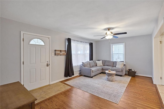 living room featuring light wood-type flooring and ceiling fan