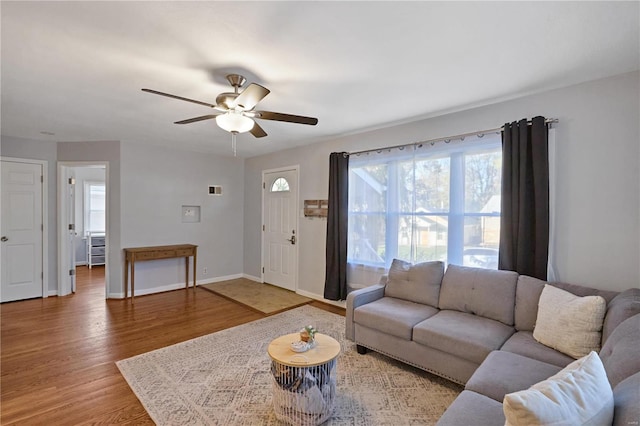 living room with hardwood / wood-style flooring and ceiling fan