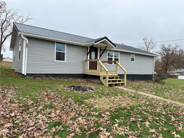 back of house with a lawn