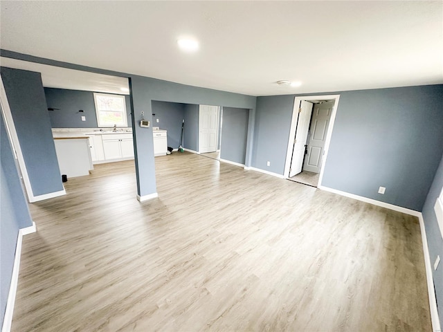 interior space featuring light wood-type flooring and sink