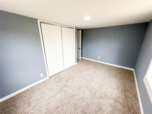 unfurnished bedroom with carpet and a closet