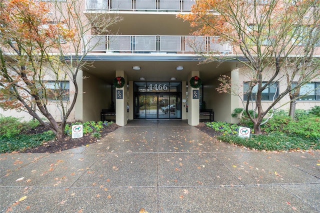 entrance to property featuring french doors and a balcony