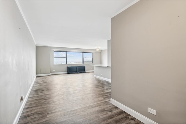 unfurnished living room with hardwood / wood-style floors and ornamental molding