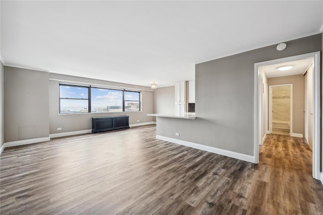 unfurnished living room with dark wood-type flooring and ornamental molding