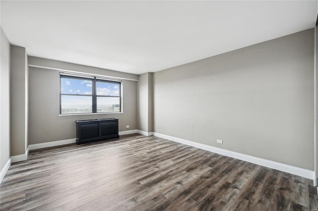 unfurnished room with wood-type flooring