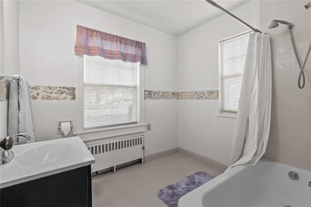 bathroom featuring shower / tub combo, vanity, and radiator