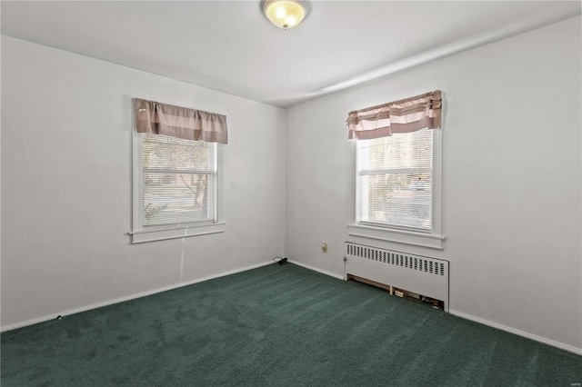 unfurnished room with dark carpet and radiator