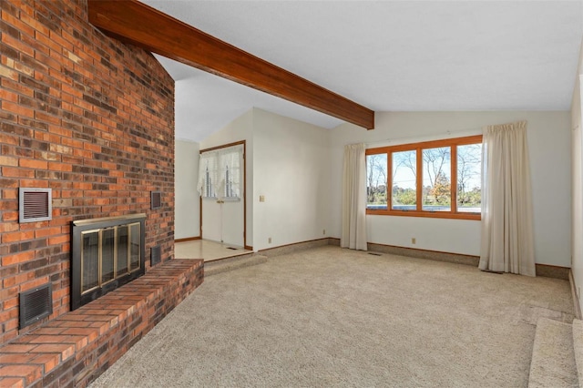 unfurnished living room featuring carpet, a fireplace, and lofted ceiling with beams