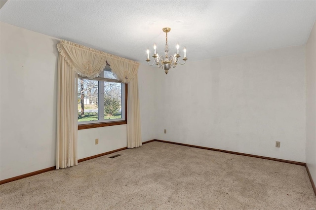 unfurnished room with a chandelier, a textured ceiling, and carpet