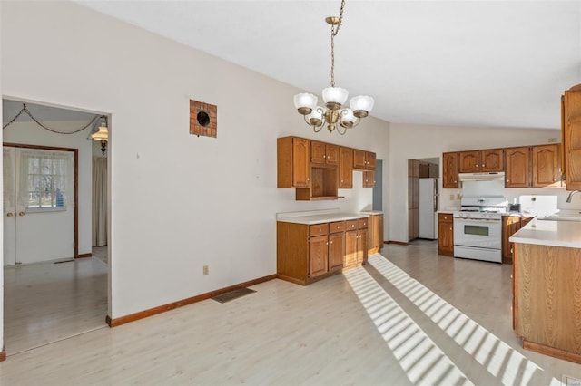 kitchen featuring sink, decorative light fixtures, white appliances, lofted ceiling, and a notable chandelier