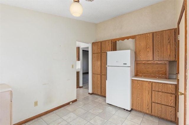 kitchen featuring light tile patterned floors and white fridge