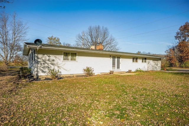 rear view of house with a lawn