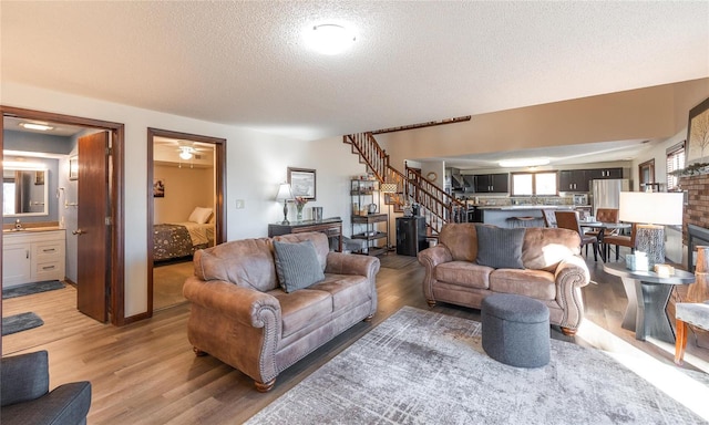 living room featuring wood-type flooring and a textured ceiling