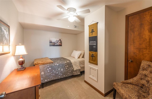 bedroom featuring ceiling fan and light carpet