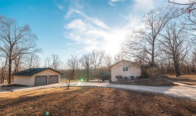 view of side of property with a garage and an outdoor structure