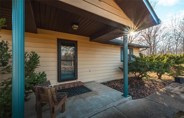 view of exterior entry featuring a patio area