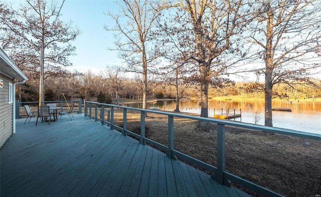 wooden deck featuring a water view and a boat dock