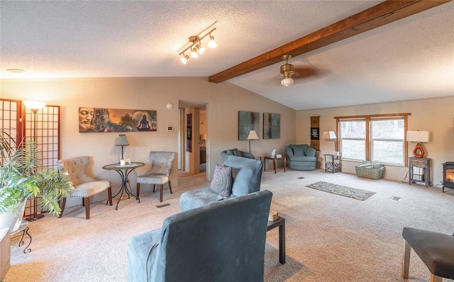 living room featuring vaulted ceiling with beams, light colored carpet, a textured ceiling, and a wood stove