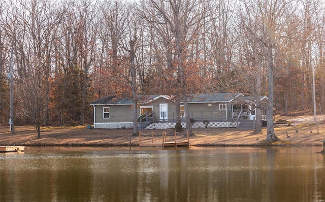 view of front of home with a deck with water view