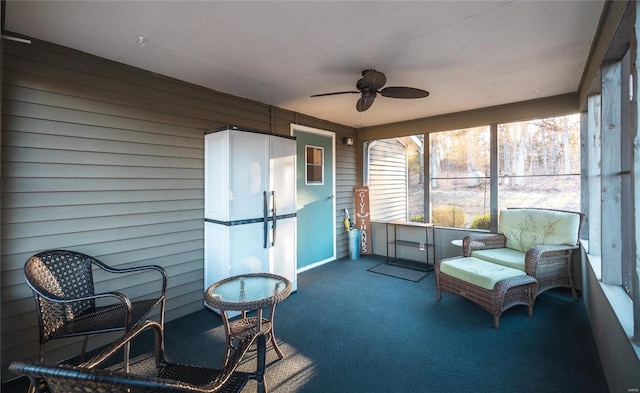 sunroom featuring ceiling fan