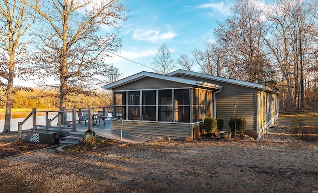 view of front of house with a wooden deck and a sunroom