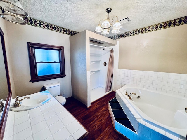 full bathroom featuring hardwood / wood-style floors, a textured ceiling, toilet, and plus walk in shower