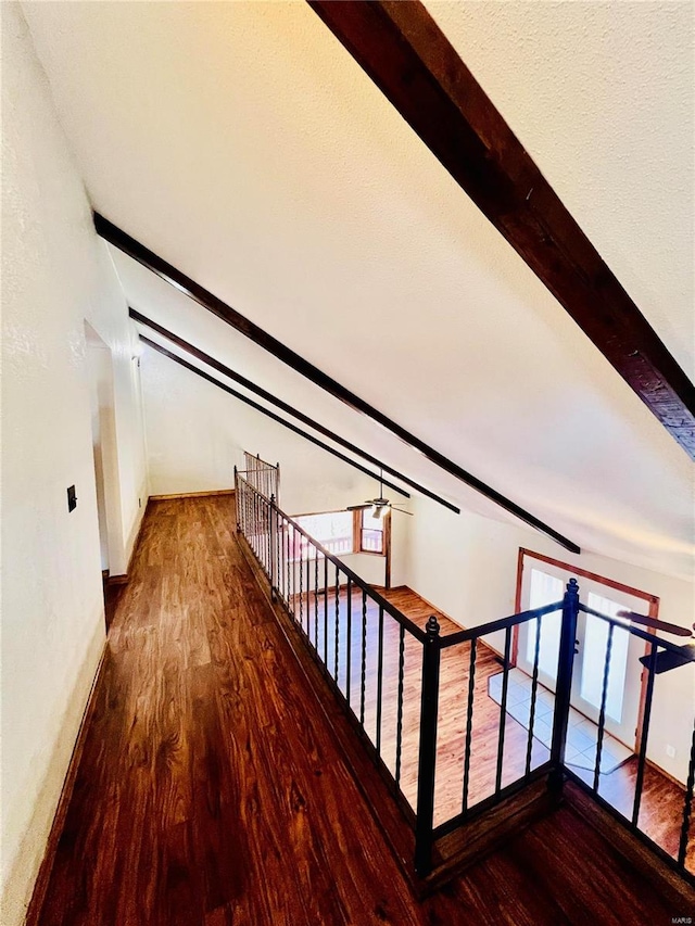 stairway with hardwood / wood-style flooring, plenty of natural light, and lofted ceiling with beams