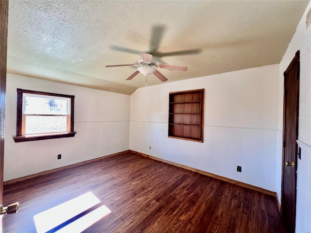 empty room with a textured ceiling, hardwood / wood-style flooring, and ceiling fan