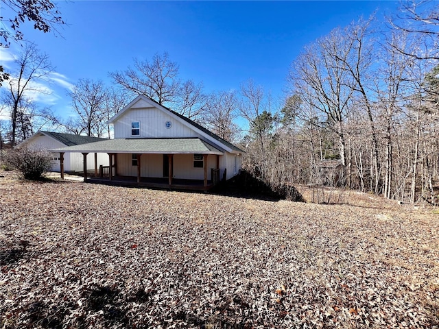 view of side of home featuring covered porch