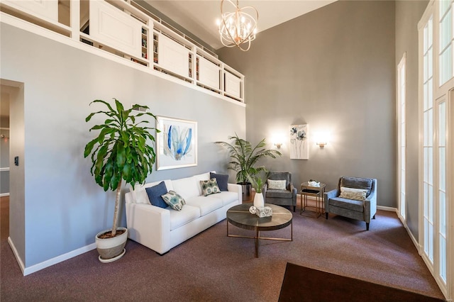 carpeted living room featuring a high ceiling and a notable chandelier