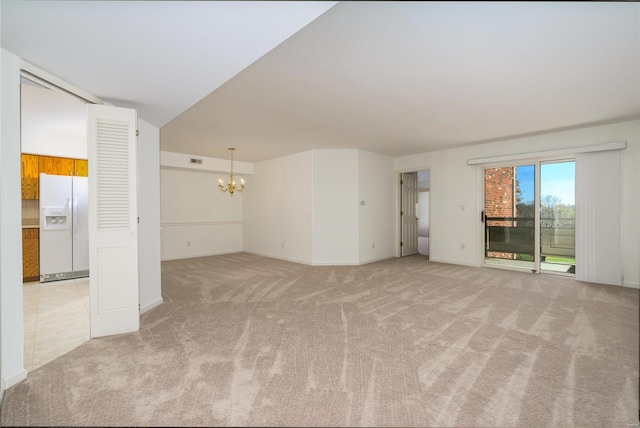 unfurnished living room with light carpet and a notable chandelier