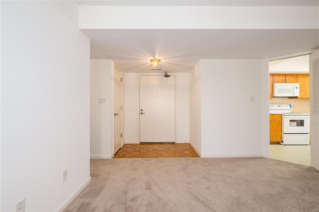 unfurnished room featuring light carpet