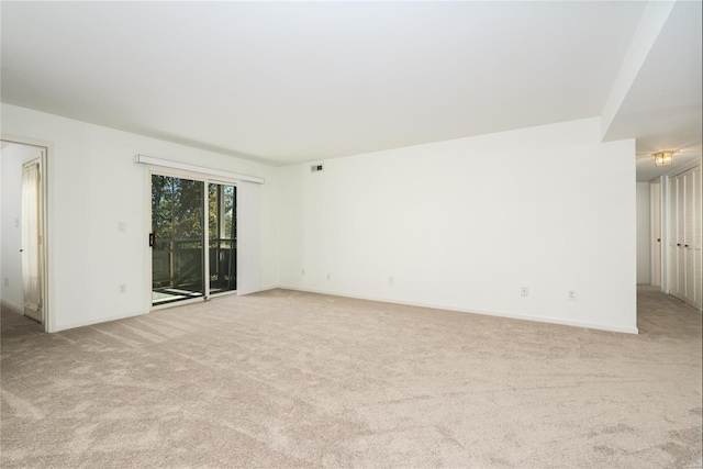 unfurnished room with light carpet