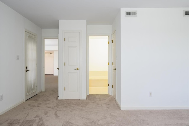 unfurnished bedroom with light carpet