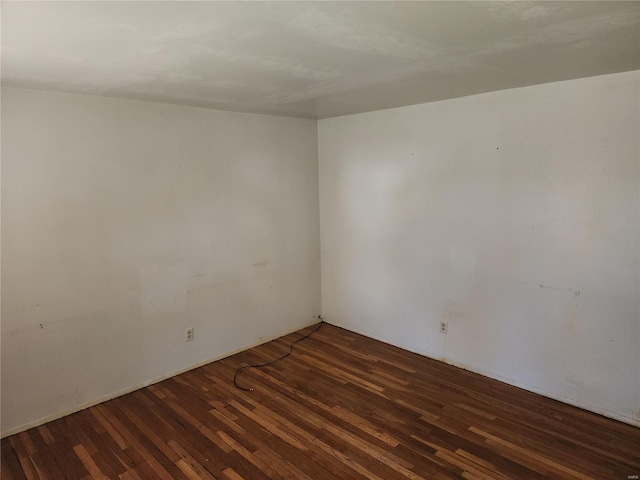 spare room featuring dark hardwood / wood-style floors