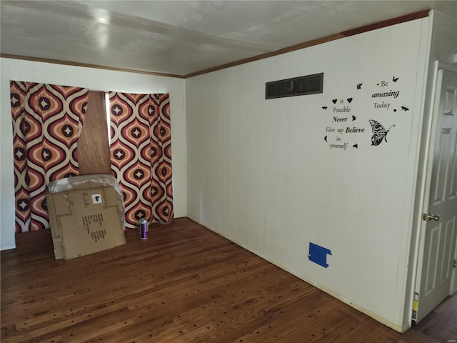 unfurnished room featuring dark hardwood / wood-style flooring and ornamental molding