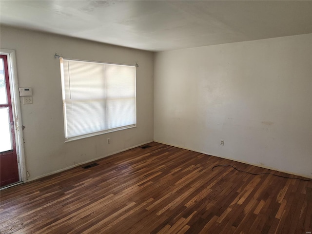 unfurnished room featuring dark wood-type flooring