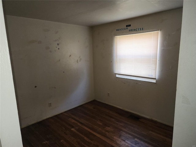 empty room with dark wood-type flooring