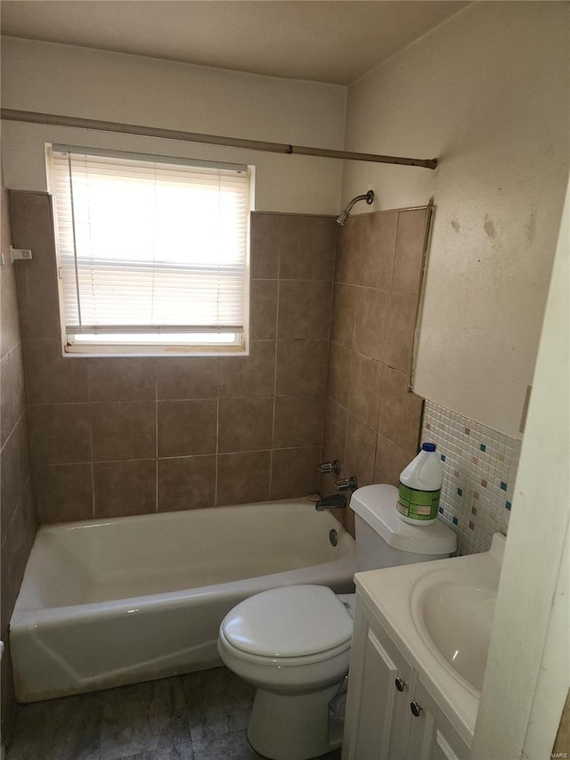 full bathroom featuring toilet, vanity, and tiled shower / bath