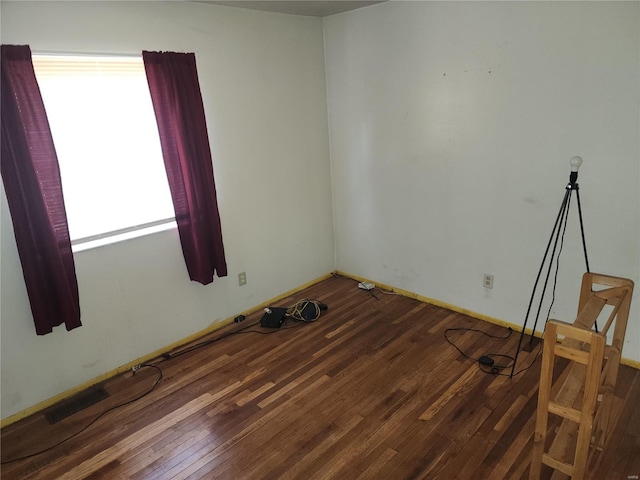 spare room with hardwood / wood-style floors