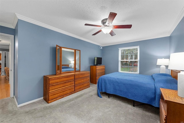 bedroom featuring ceiling fan, crown molding, a textured ceiling, and light carpet