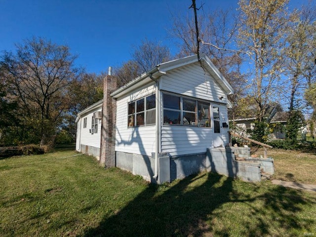 view of side of property with a lawn