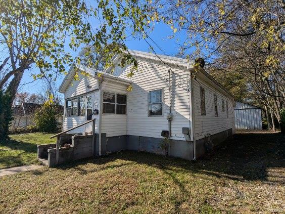 view of property exterior with a yard