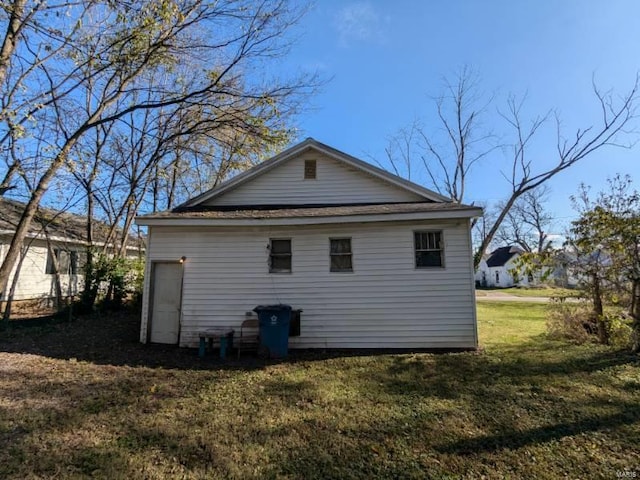 rear view of house with a yard