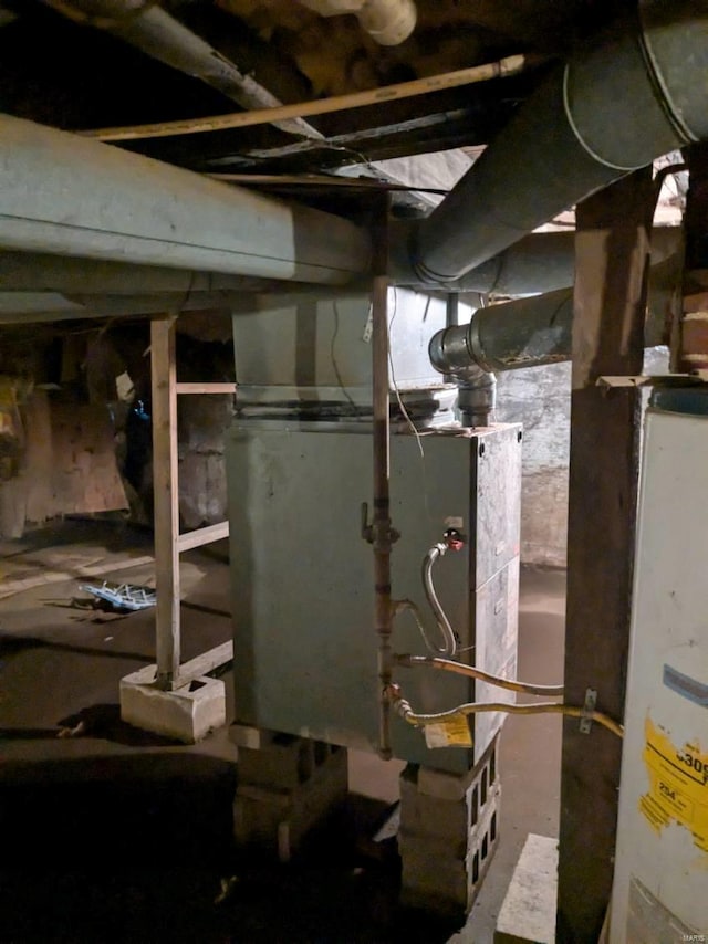 utility room featuring water heater and heating unit