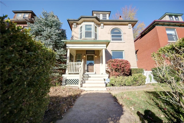 italianate house with covered porch and brick siding